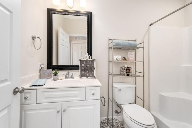 unfurnished bedroom featuring a walk in closet, crown molding, a closet, carpet flooring, and baseboards