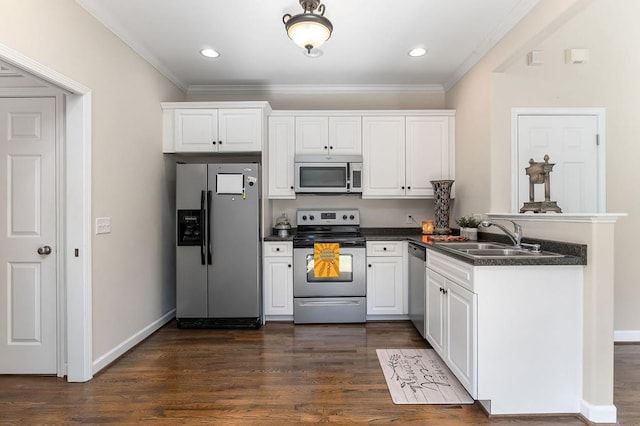 kitchen featuring appliances with stainless steel finishes, dark wood-type flooring, dark countertops, and a sink