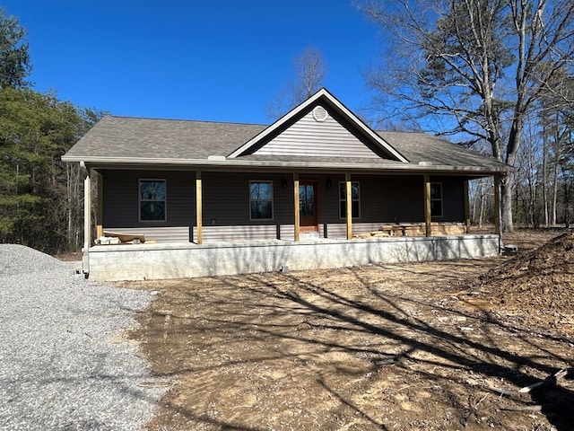 view of front of property with a shingled roof and covered porch