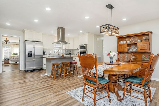 dining space with recessed lighting, ceiling fan, and light wood finished floors