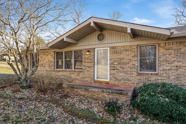 view of side of property with brick siding