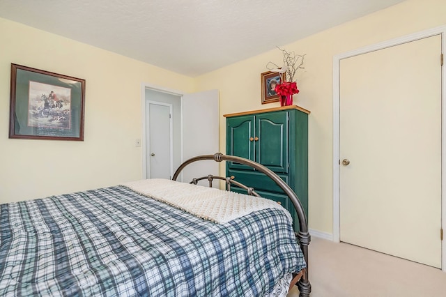 bedroom featuring light carpet and baseboards