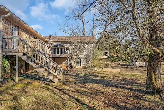 view of yard with a wooden deck and stairs