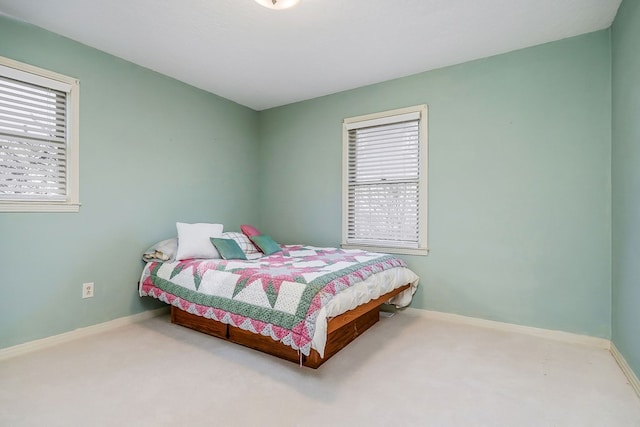 carpeted bedroom with baseboards