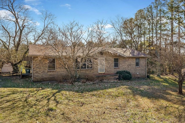 single story home featuring a front yard and brick siding