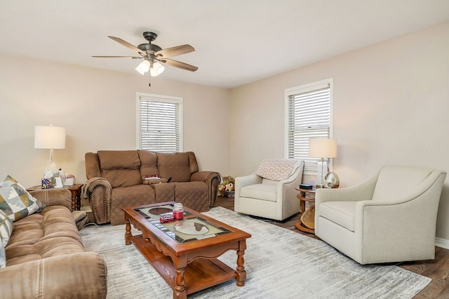 living area with ceiling fan and wood finished floors