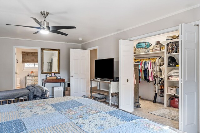 bedroom with light carpet, a ceiling fan, ornamental molding, a closet, and ensuite bath