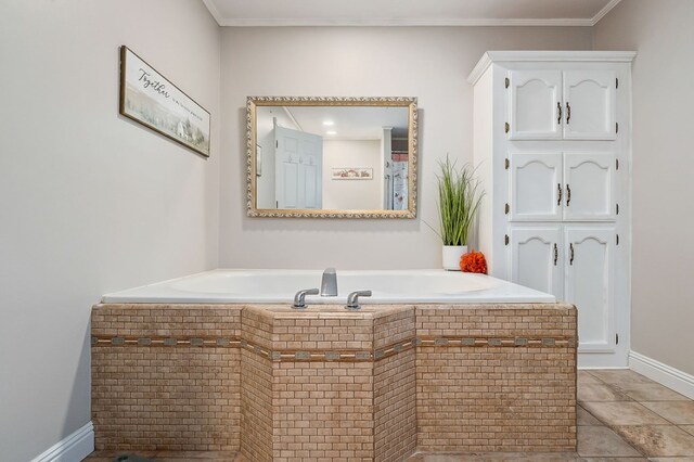 bathroom featuring ornamental molding, tile patterned flooring, a tub, and baseboards