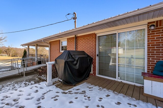 snow covered deck with grilling area