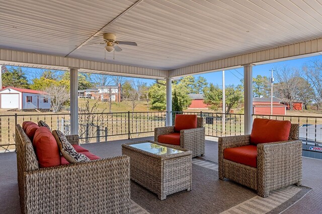 sunroom / solarium featuring a healthy amount of sunlight and ceiling fan