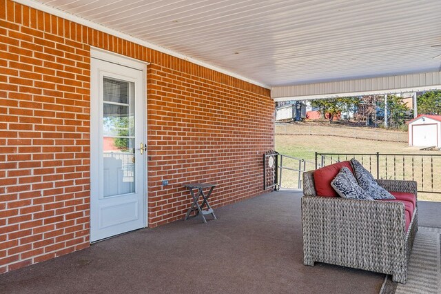 view of patio / terrace featuring a storage unit