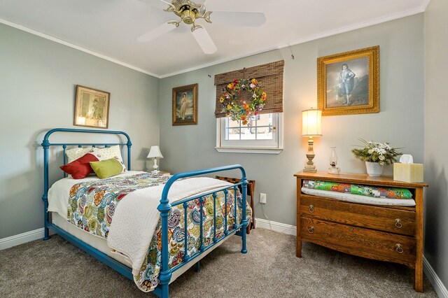 carpeted bedroom with ceiling fan, baseboards, and crown molding