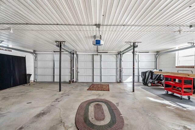 garage featuring metal wall and a garage door opener