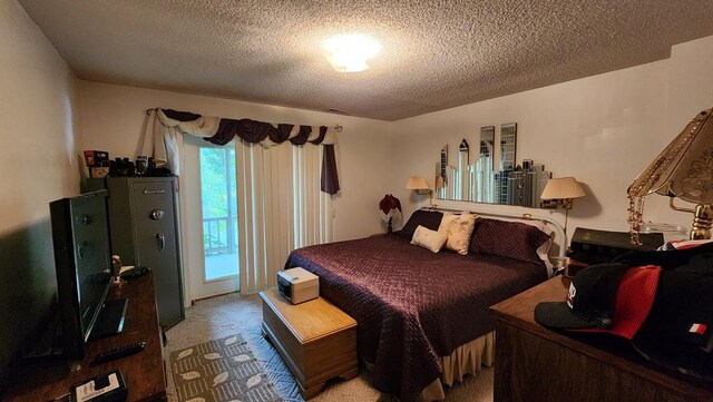 bedroom featuring a textured ceiling, carpet floors, and access to exterior