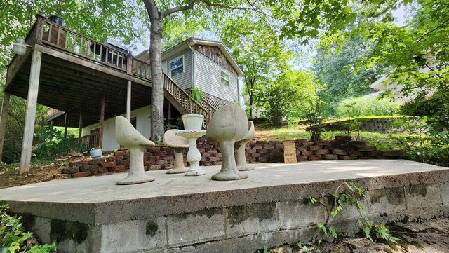 exterior space featuring a deck, a patio, and stairway