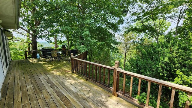 wooden terrace featuring outdoor dining area