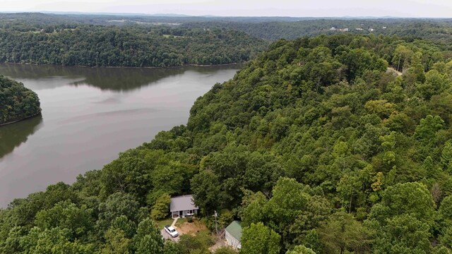 aerial view featuring a water view and a wooded view