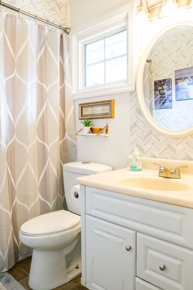 full bath with toilet, tile patterned flooring, and vanity