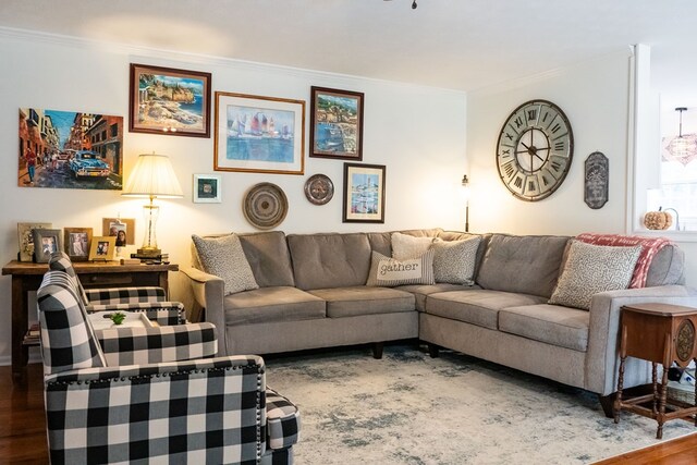 living area featuring crown molding and wood finished floors