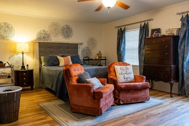 bedroom with ornamental molding, light wood finished floors, and a ceiling fan