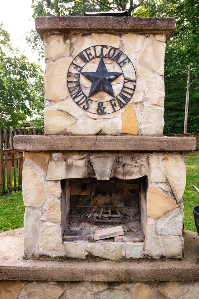 details with an outdoor stone fireplace