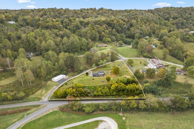 birds eye view of property featuring a view of trees