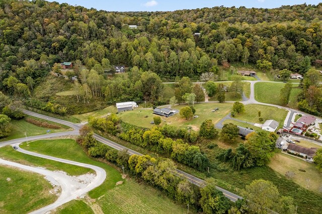 drone / aerial view with a wooded view