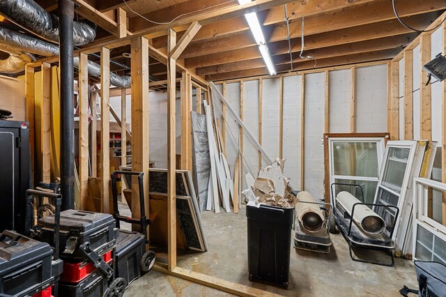 unfinished basement with concrete block wall