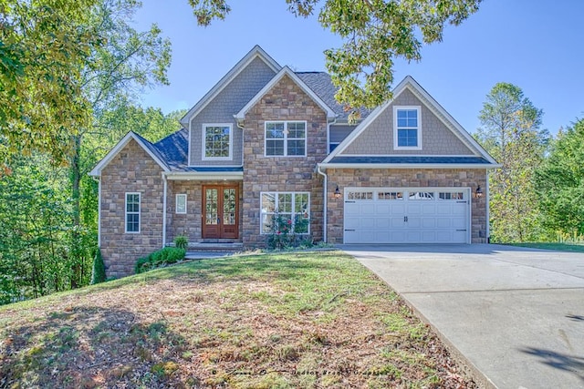 craftsman-style home with a garage, french doors, and concrete driveway