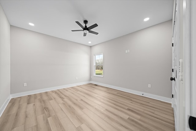 spare room featuring light wood finished floors, baseboards, a ceiling fan, and recessed lighting