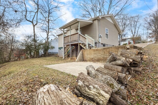 back of house featuring a patio area, a yard, and stairs