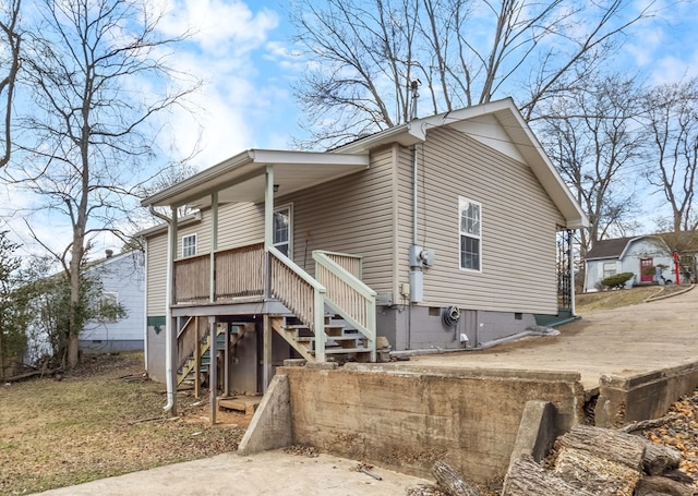 view of side of home featuring stairway