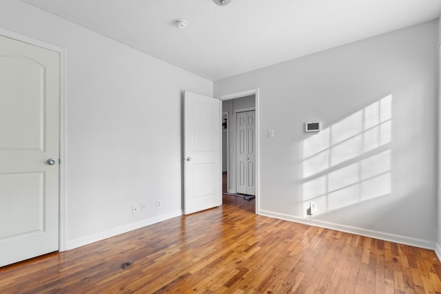 interior space with baseboards and wood finished floors