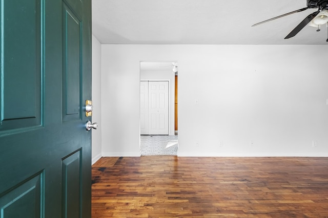 foyer with baseboards, dark wood finished floors, and a ceiling fan