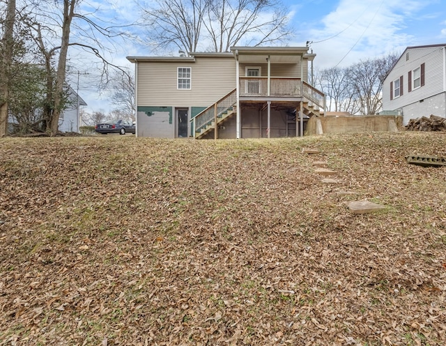 rear view of property with stairs