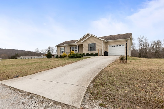 ranch-style home with driveway, a garage, central AC unit, and a front lawn