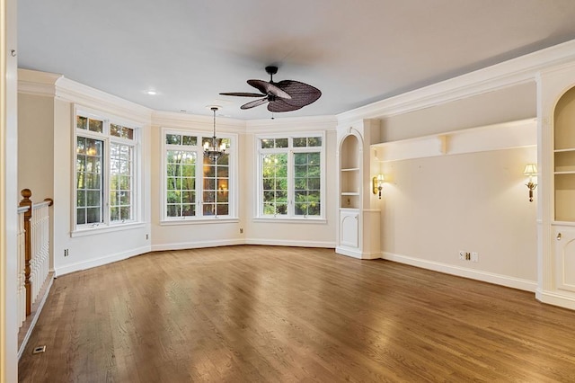 interior space with a healthy amount of sunlight, baseboards, ornamental molding, and wood finished floors