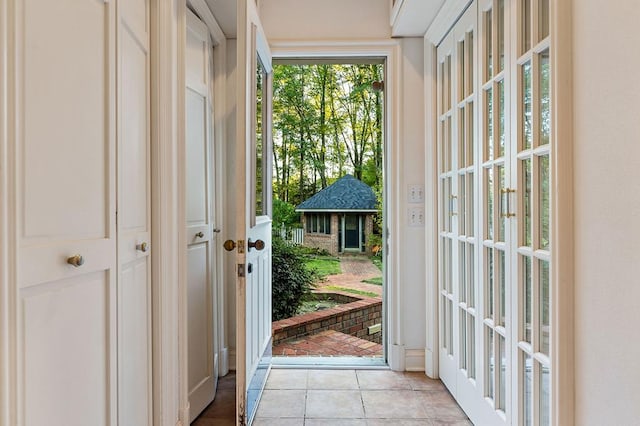 doorway featuring french doors and light tile patterned floors