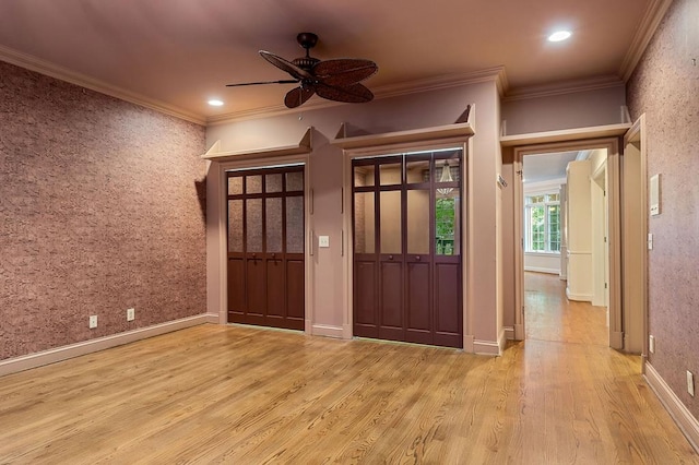 unfurnished room featuring baseboards, light wood finished floors, a ceiling fan, and crown molding