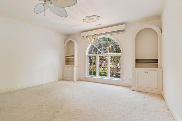 unfurnished room featuring light carpet, built in shelves, crown molding, and baseboards