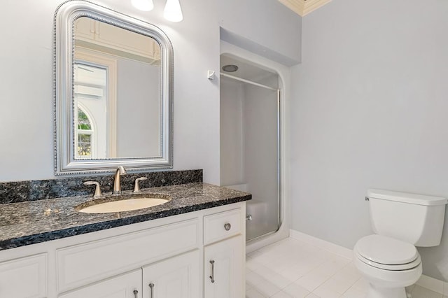 bathroom featuring a stall shower, baseboards, toilet, tile patterned flooring, and vanity