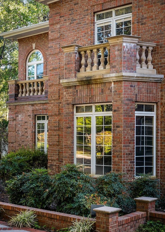 entrance to property featuring brick siding