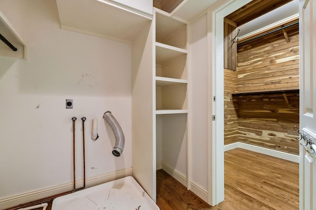 interior space featuring hookup for a washing machine, laundry area, hookup for an electric dryer, and wood finished floors