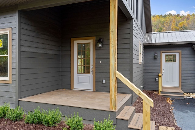 view of exterior entry featuring metal roof