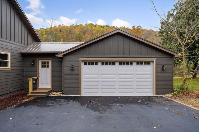 garage featuring aphalt driveway