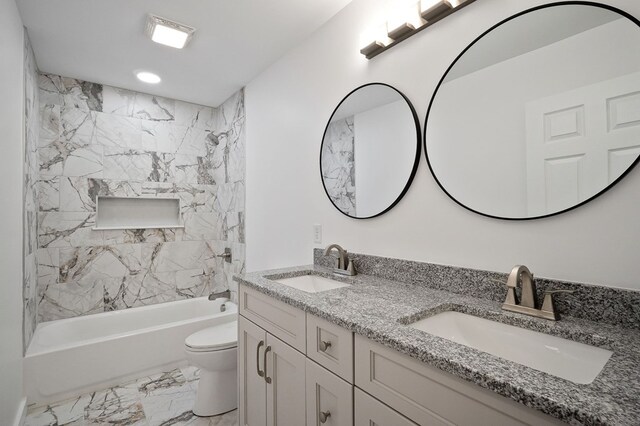 bathroom with toilet, marble finish floor, a sink, and shower / tub combination