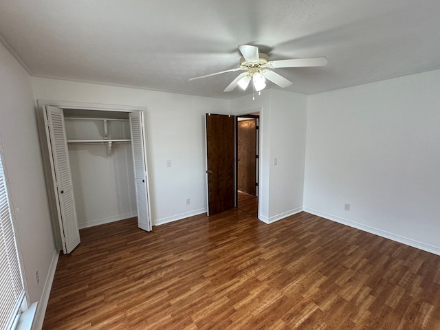 unfurnished bedroom with a closet, ceiling fan, baseboards, and wood finished floors