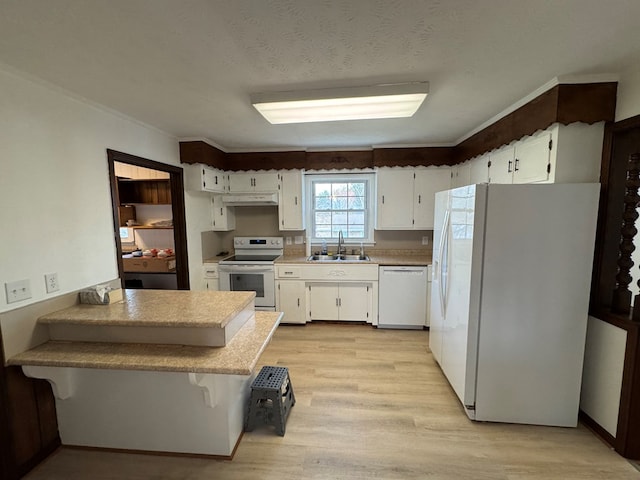 kitchen featuring white appliances, light wood finished floors, a sink, white cabinets, and under cabinet range hood