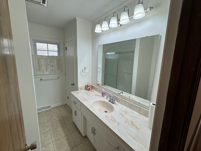 bathroom with an enclosed shower, visible vents, crown molding, tile patterned flooring, and vanity