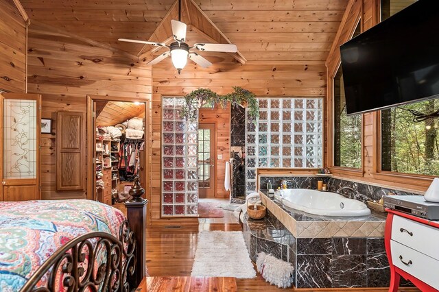 bedroom featuring lofted ceiling, wood walls, and wooden ceiling